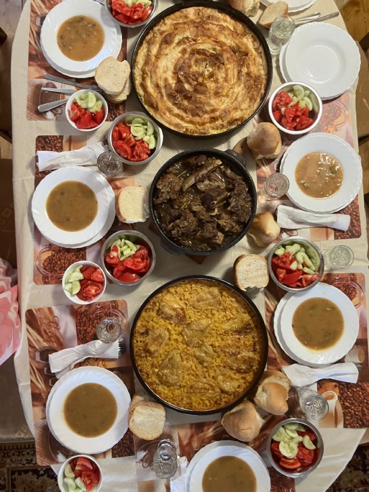 a table topped with lots of different types of food and bowls filled with sauces