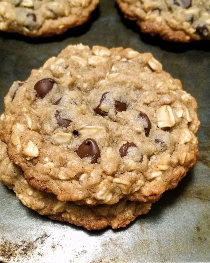 cookies with chocolate chips and oatmeal are on a baking sheet