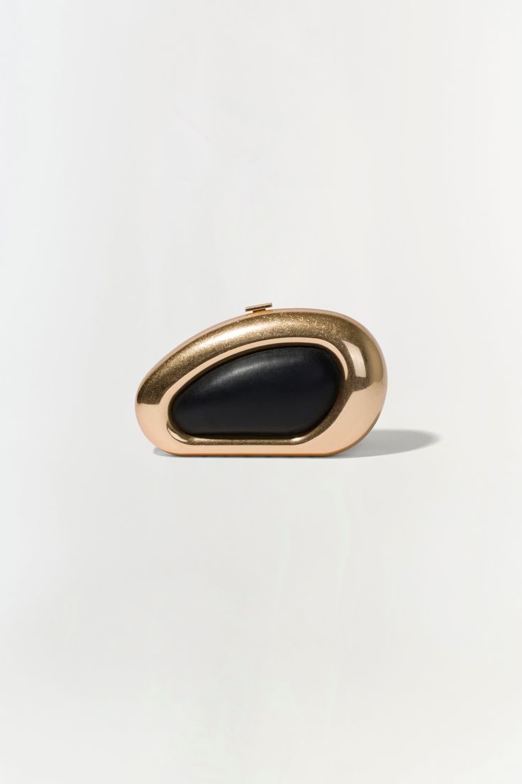 FALL 2024 WOMEN'S COLLECTION The Luna Clutch in Black Gold. Featuring a sleek gold frame and sophisticated black center, elevate your evening ensemble with this chic oval clutch. Elegant Structured Clutch For Formal Occasions, Elegant Structured Formal Clutch, Modern Formal Evening Bag, Modern Structured Clutch For Formal Occasions, Gold Chic Clutch For Formal Occasions, Classic Gold Clutch For Events, Elegant Evening Bag With Gold-tone Hardware For Formal Events, Luxury Gold Clutch For Night Out, Modern Black Evening Bag For Night Out