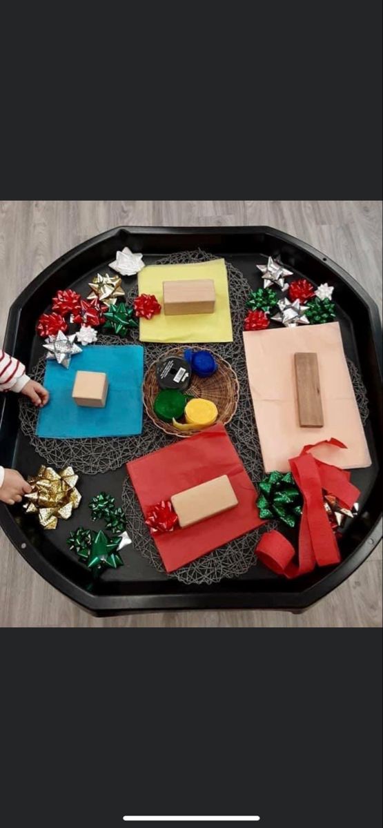 the tray is decorated with different types of paper and decorations on it, including presents