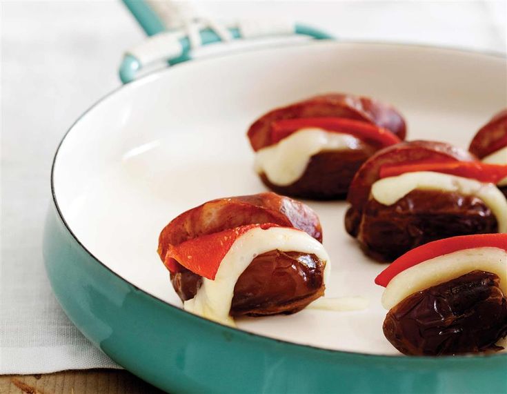 dates wrapped in cheese and pepper on a plate