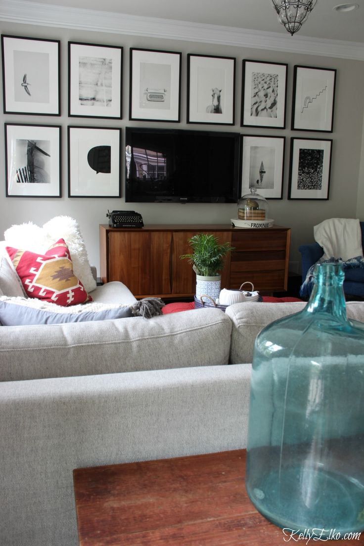 a living room filled with furniture and pictures on the wall