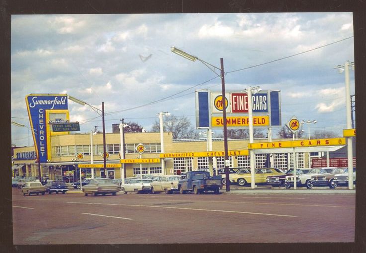 cars are parked in front of a gas station