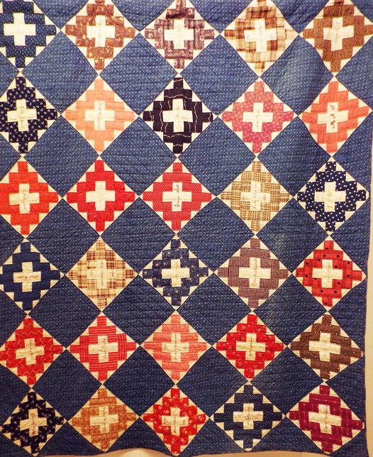 a blue and red quilt with crosses on it