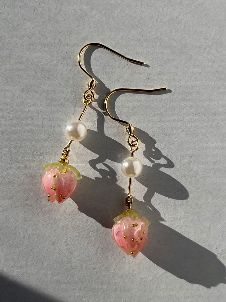 These are fun, cute strawberry earrings hand made with love <3. The hooks are gold plated. Strawberries come in pink or red. Sweet Pink Drop Earrings, Sweet Pink Dangle Jewelry, Pink Fruit Design Jewelry, Handmade Pink 14k Gold Filled Earrings, Handmade Pink 14k Gold-filled Earrings, Pink Fruit Design Earrings, Trendy Pink Jewelry With Fruit Design, Cute Fruit Design Dangle Jewelry, Cute Dangle Earrings With Fruit Design