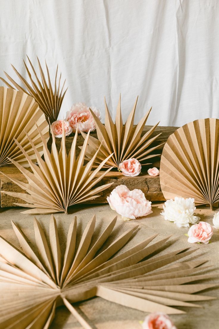 several fan shaped paper flowers on a table