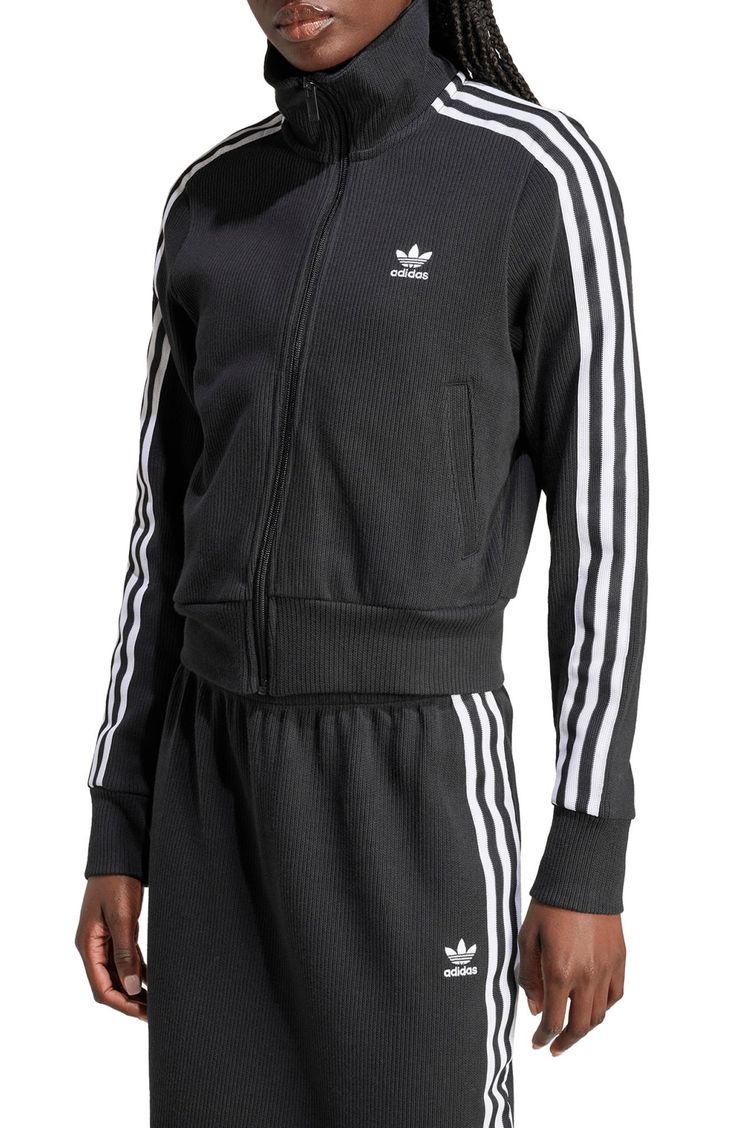 Made from a blend of cotton and recycled yarns, this ribbed track jacket with the 3-Stripes will keep you both comfy and sporty. Front zip closure Stand collar Front welt pockets 79% cotton, 21% recycled polyester Machine wash, dry flat Imported Winter Sportswear Track Jacket With Ribbed Cuffs, Fall Athleisure Activewear With Three Stripes, Three Stripes Activewear For Spring Streetwear, Sporty Long Sleeve Activewear With Three Stripes, Adidas-style Winter Sportswear Activewear, Sportswear Track Jacket With Ribbed Collar For Fall, Hooded Track Jacket With Three Stripes For Fall, Winter Athleisure Activewear With Three Stripes, Winter Athleisure Track Jacket With Ribbed Cuffs