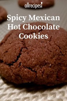 a close up of a chocolate cookie on a baking sheet with the words spicy mexican hot chocolate cookies