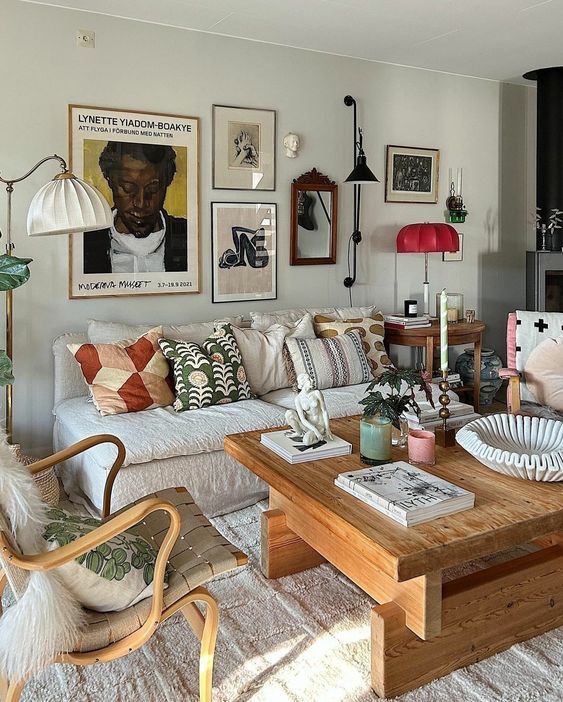 a living room filled with furniture and pictures on the wall