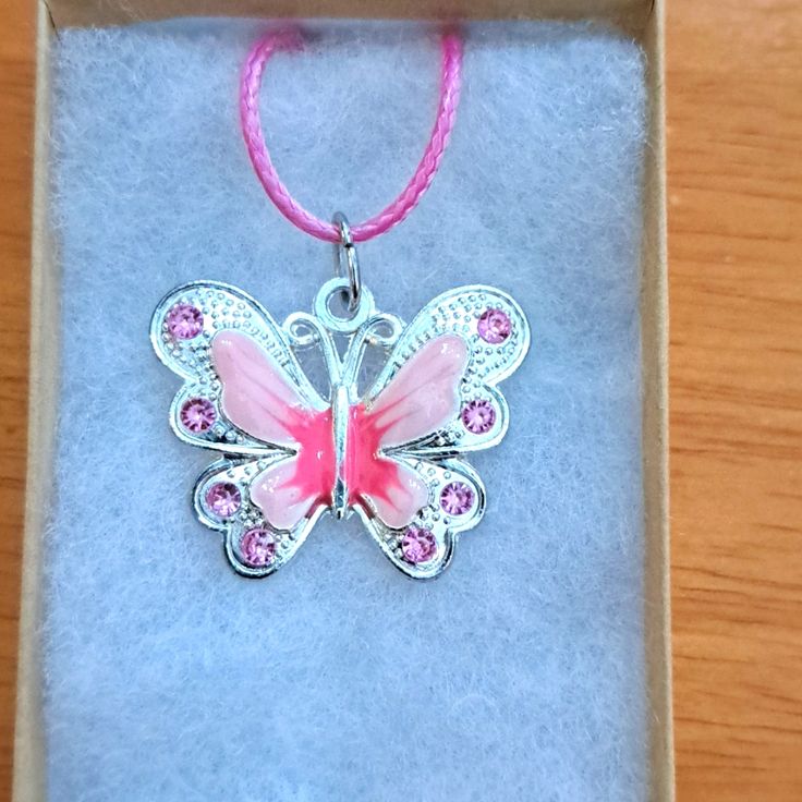 Handmade Pink Crystal Butterfly Necklace Made With Enamel Butterfly On Pink Cord Chain. Pendant Butterfly Measures 28mm In Shining Plated Silver. Pendant Features Enamel Pink Shades With Pink Crystal Stones. The Butterfly Is A Symbol Of Endurance And Hope. Chain Is Adjustable With Claw Clasp Closure. Box Display Only. Pouch Included Free. New And Unused Item. Contact Me With Any Offers. Cute Silver Charm Necklaces With Lobster Clasp, Cute Nickel-free Pendant Jewelry, Cute Hypoallergenic Silver Charm Necklaces, Cute Nickel-free Silver Charm Necklace, Cute Silver Nickel-free Charm Necklace, Cute Silver Nickel-free Charm Necklaces, Silver Butterfly Charm Jewelry, Cute Silver Pendant Charm Necklace, Cute Silver Jewelry With Butterfly Charm