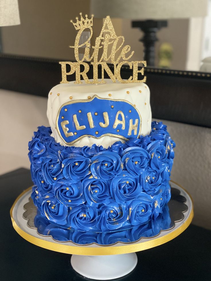 a blue and white cake sitting on top of a table