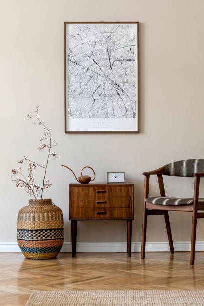 a room with a chair, table and vase on the floor