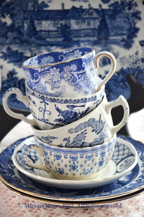 a stack of blue and white china cups and saucers on top of each other