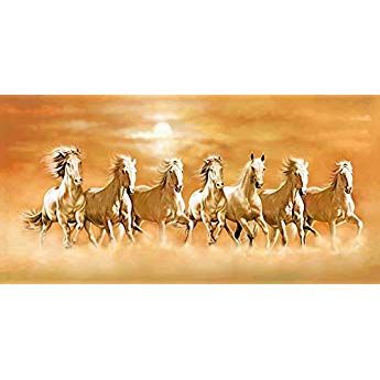 a group of horses running across a field with an orange sky in the back ground