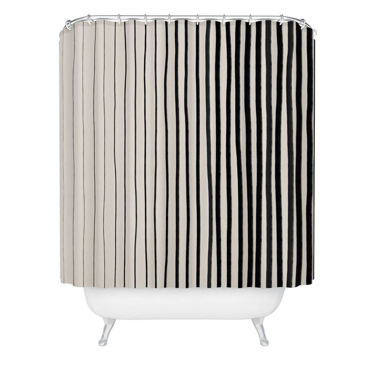 a black and white shower curtain with vertical stripes on the bottom, in front of a white bathtub