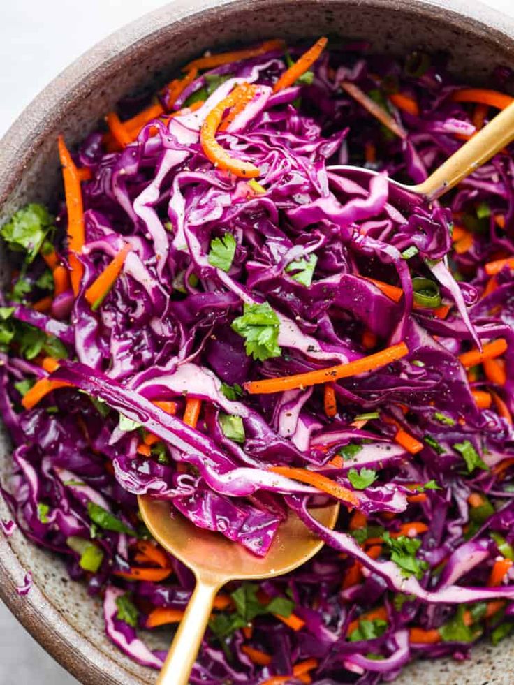 a white plate topped with red cabbage and carrots