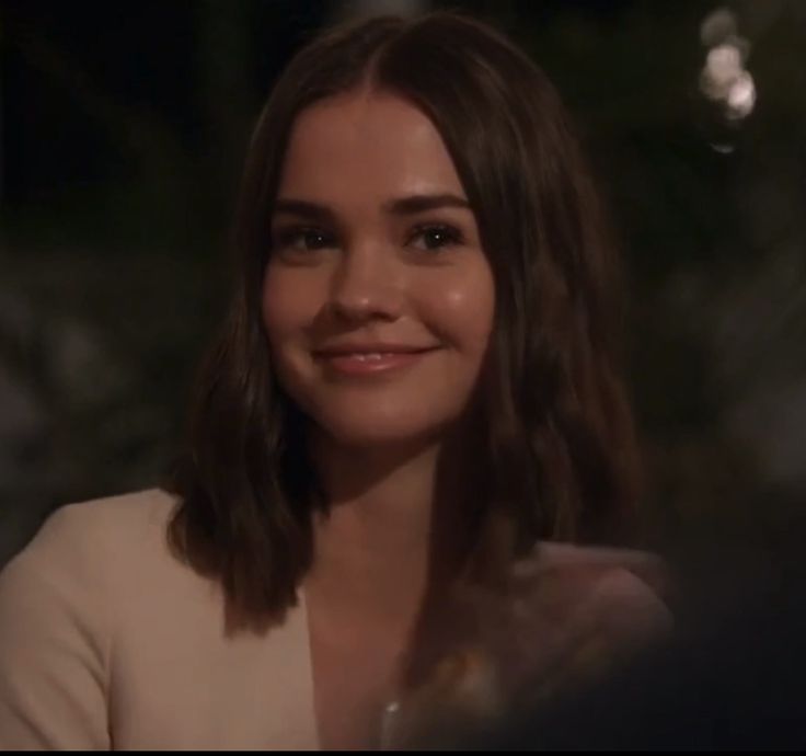 a close up of a person sitting at a table