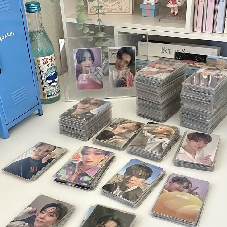 a table topped with lots of cards and pictures next to a blue locker filled with photos