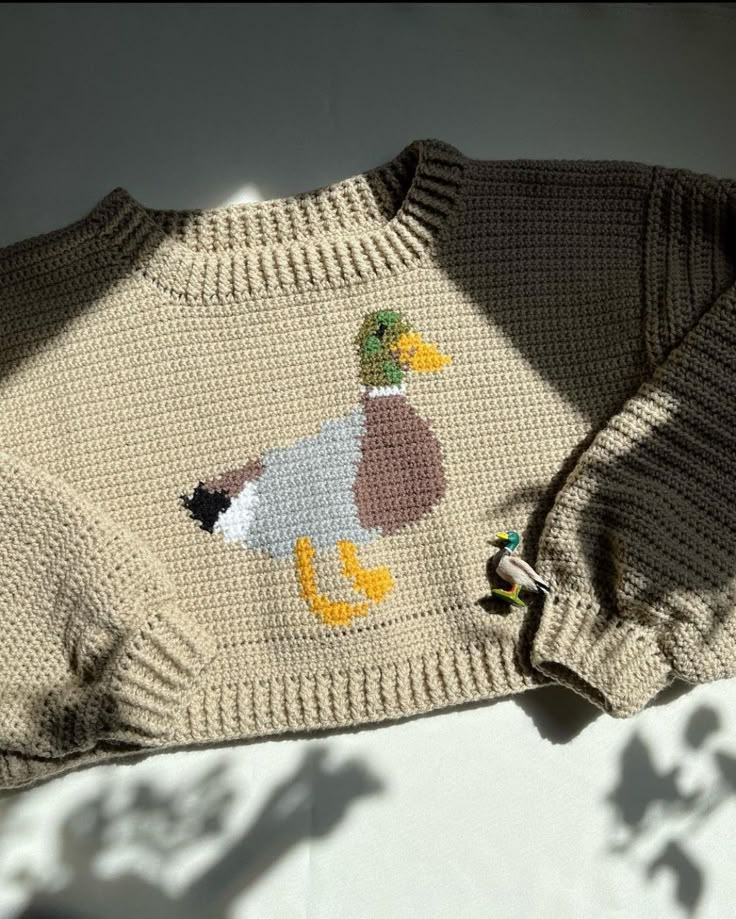 a knit sweater with a duck on it