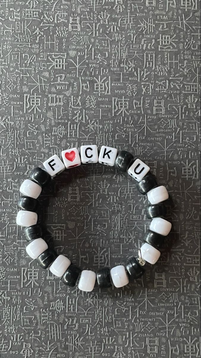 a black and white bracelet with the word f is for f k u on it