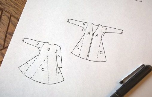 the paper has drawings of dresses on it