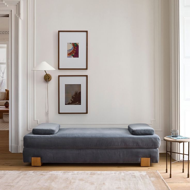 a living room filled with furniture and pictures on the wall