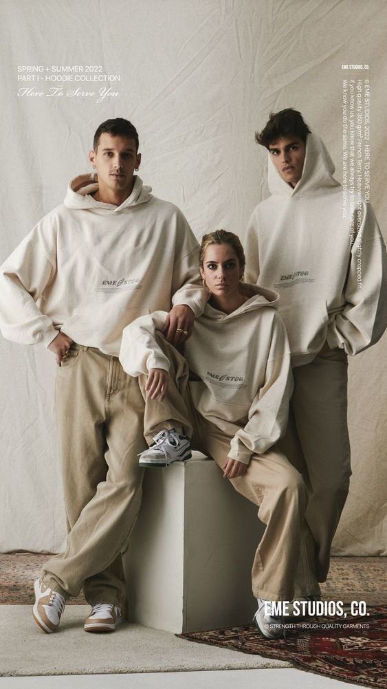 two men and a woman wearing oversized sweatshirts