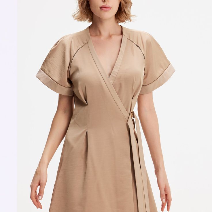 A minimalist and chic cut, this dress elegantly emphasizes any type of silhouette: fitted to the waist not a wallet system, wide raglan cuffs, V neckline and flared volume. Refined finishes with inlaid openwork braid and satin trim at the sleeves and along the neckline. A timeless cut in a soft poplin-type fabric that is easy to iron. This dress adapts to various occasions and will be a chic and safe option for your evenings or for the office. Main fabric:  100% Polyester Finishes: 65% Viscose, Elegant Short Sleeve V-neck Dress For Brunch, Chic A-line Wrap Dress For Formal Occasions, Semi-formal Solid V-neck Dress, Solid Color V-neck Dress For Semi-formal Occasions, Modern V-neck Dress For Work, Solid V-neck Dress For Semi-formal Occasions, Solid Color V-neck Dress For Summer Workwear, Summer Solid Color V-neck Dress For Workwear, Chic Belted A-line Wrap Dress