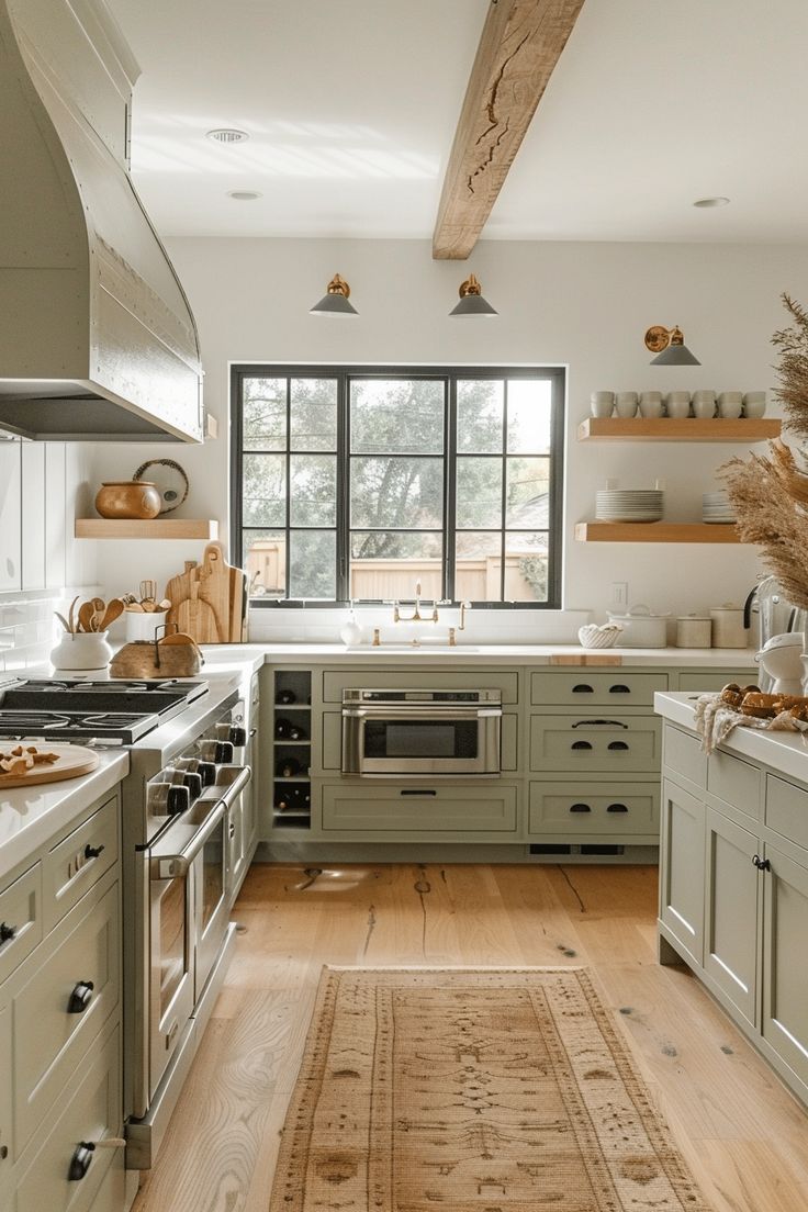 a kitchen with lots of counter space and wooden flooring, along with an area rug on the floor