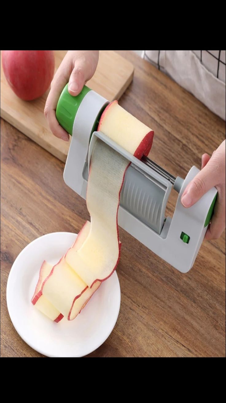 an apple slicer being used to cut apples