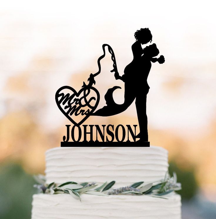 a wedding cake topper with the silhouette of a bride and groom