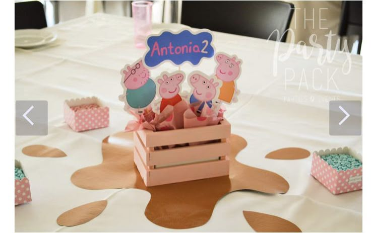 peppa pig party favors in pink boxes on a white tablecloth with polka dots