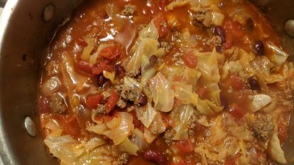 a pot filled with lots of food on top of a stove