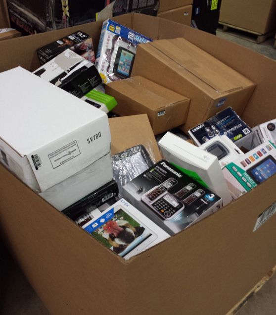 boxes full of electronic devices are stacked on top of each other in an open cardboard box