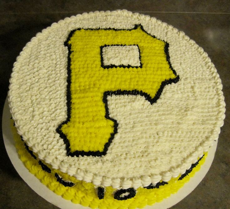 a yellow and white cake with the letter f on it