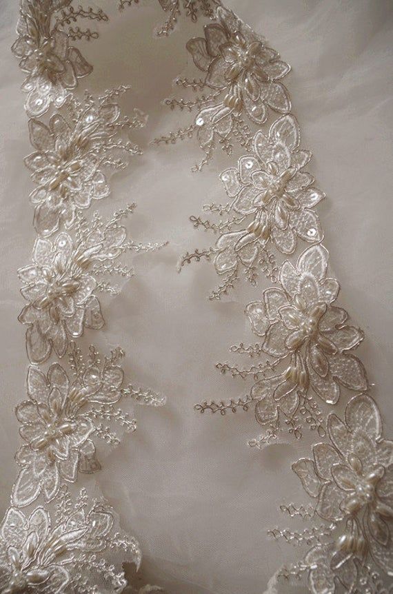 beaded Alencon Lace Trim, bridal alencon lace, wedding trim lace, scollaped lace trim, veil lace trim This amazing trim is specially for bridal gown, wedding dress, bridal veil. Super gorgeou alencon lace trim with scollaped trim, vintage style. Highly recommended for all brides ✿✿ＭＡＴＥＲＩＡＬ✿✿ alencon lace ✿✿ＭＥＡＳＵＲＥＭＥＮＴ✿✿ Width: Fixed width is 3.5 inches ✿✿ＣＯＬＯＲ✿✿ ivory ✿✿ＱＵＡＮＴＩＴＹ✿✿ This listing is for 1 yard ✿✿ＷＨＹ ＷＥ ＬＯＶＥ ＩＴ✿✿ ✿ Grace and antique design ✿ Elegant design, super poular with brides Fitted Lace Bridal Belt For Bride, Lace Bridal Accessories Fitted For Mother Of The Bride, Fitted Lace Bridal Accessories For Mother Of The Bride, Lace Wedding Dress With Lace Trim For Bride, Elegant Pearl Embroidered Lace For Wedding, Elegant Wedding Lace With Pearl Embroidery, Elegant Lace Patchwork For Wedding, Lace Wedding Dress With Lace Trim, Elegant Wedding Lace With Patchwork