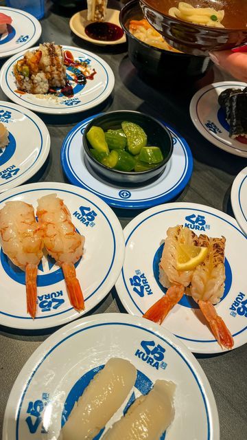 several plates with different types of food on them, including shrimp and broccoli