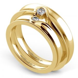 two gold wedding rings with diamonds on them