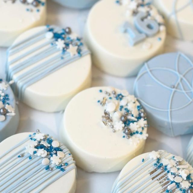 some blue and white decorated cookies on a table