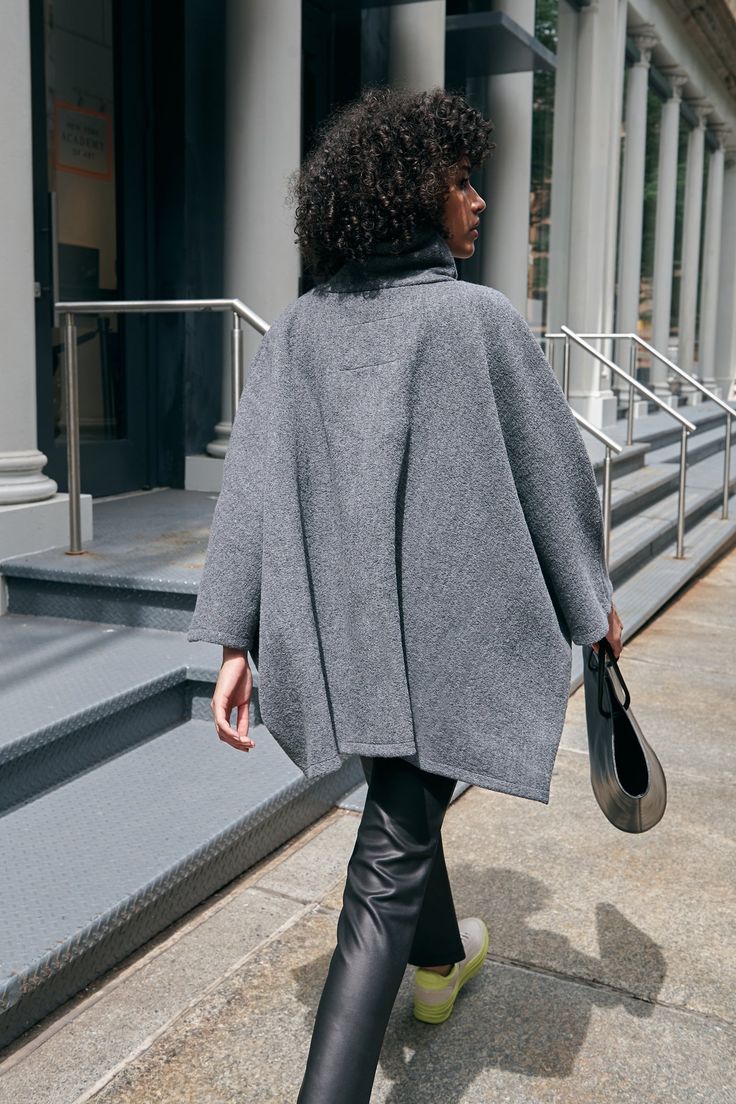 A stylish wool winter cloak, our Avery Cape is the ideal choice for heading out into the cold. Fashioned from Italian virgin wool and offered in fresh neutrals that pair well with any combination of clothing, this women’s wool cape is designed with a loose silhouette. Simple. Elegant. Cozy. Layer her over anything for an instant ready-to-go look. Avery's high collar has a side zipper for style and easy wear. This wool winter cape is lined for added warmth and comfort. | Astrid, in medium grey an Oversized Cashmere Wool Coat For Winter, Oversized Cashmere Outerwear For Winter, Elegant Oversized Wool Poncho, Chic Merino Wool Outerwear For Work, Oversized Chic Wool Poncho, Oversized Wool Outerwear For Cold Weather, Elegant Wool Poncho For Workwear, Chic Fall Cape For Workwear, Elegant Fall Poncho For Workwear