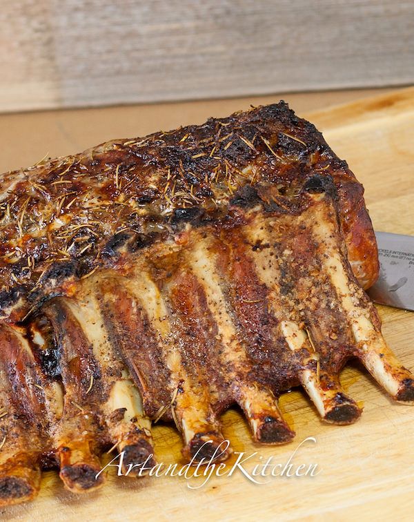 a large piece of meat sitting on top of a cutting board next to a knife