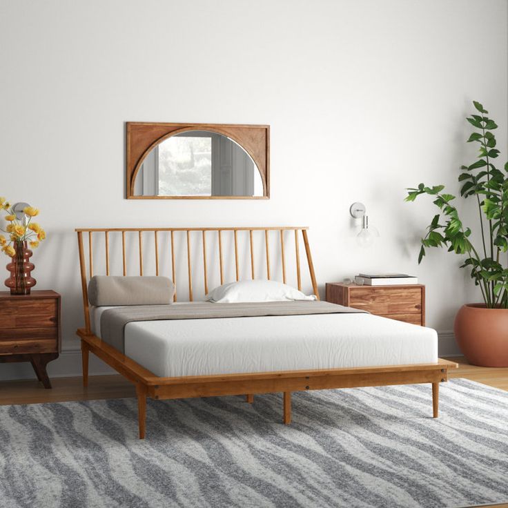 a white bed sitting on top of a wooden frame