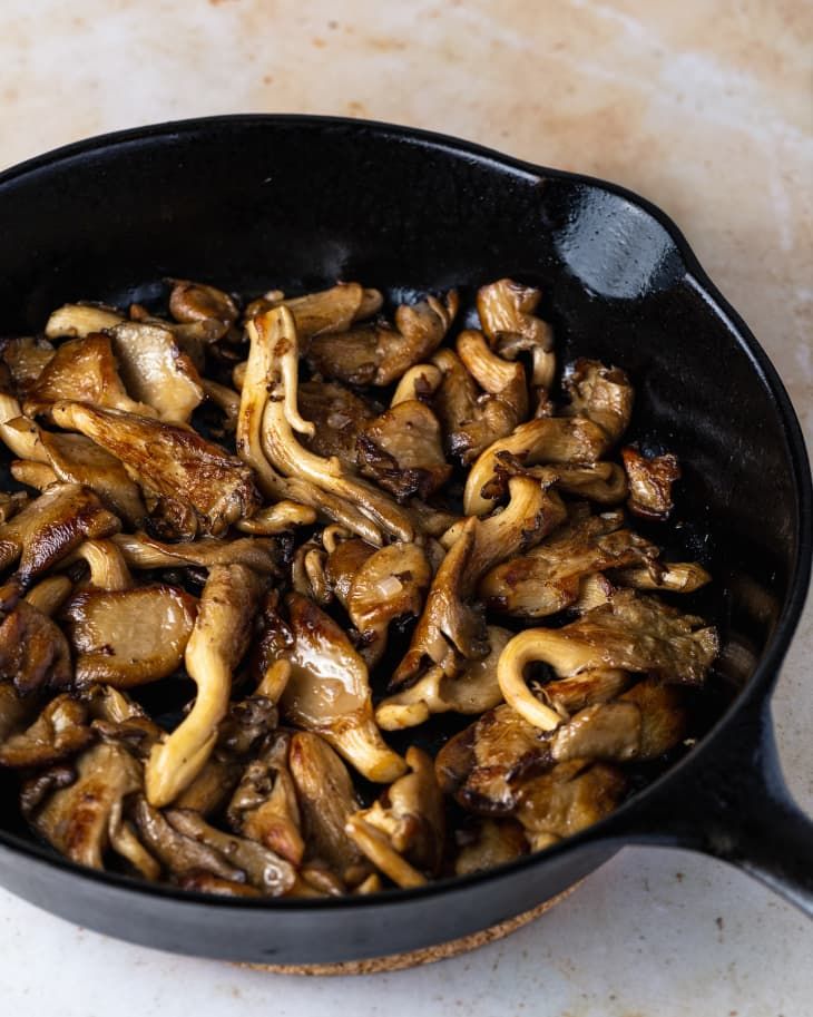 mushrooms are cooking in a skillet on the counter