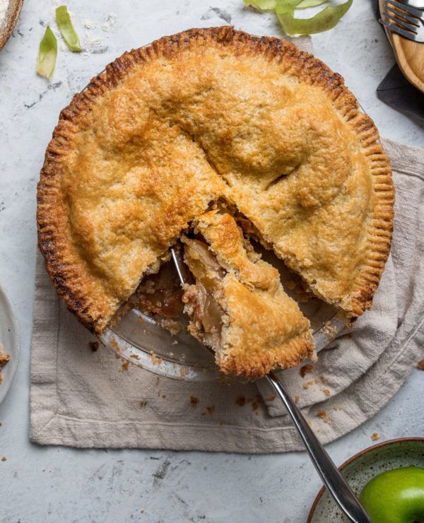 an apple pie with one slice taken out