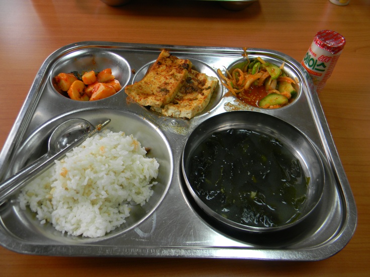 a metal tray filled with different types of food