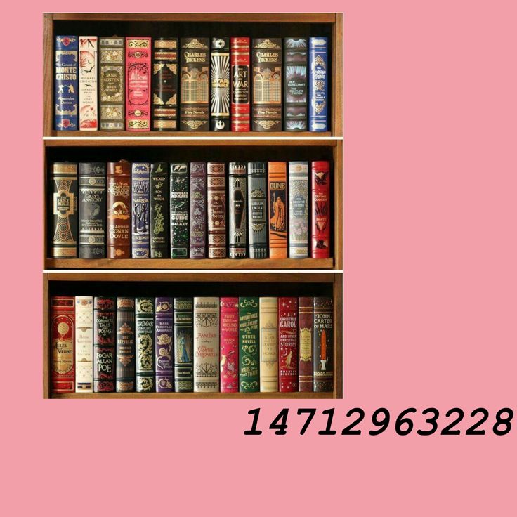 a book shelf filled with lots of books on top of a pink wall next to a clock