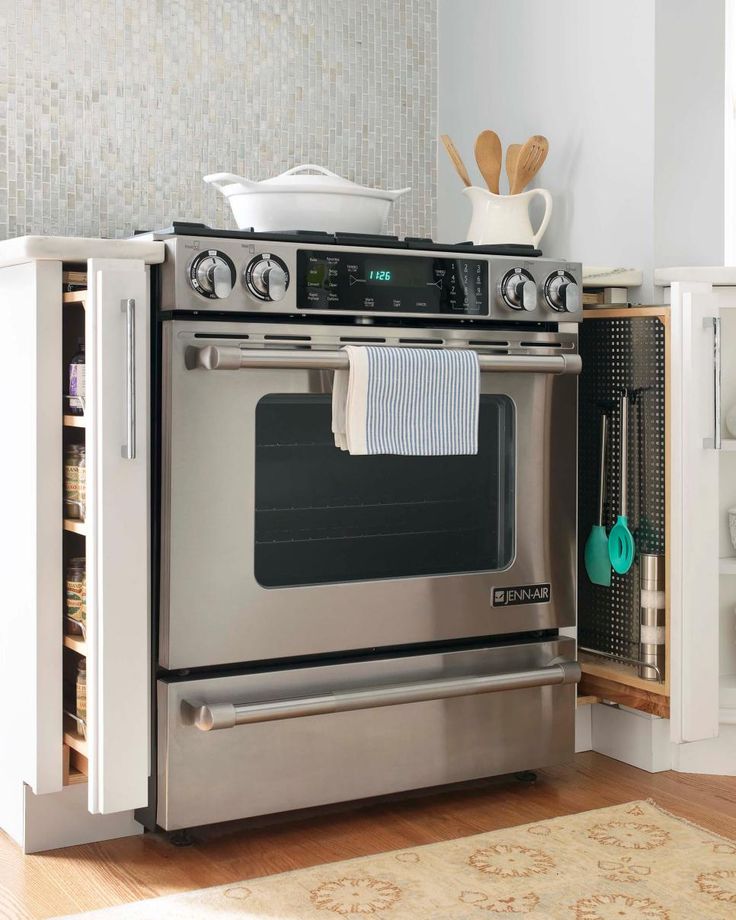 a kitchen with an oven, stove and utensils