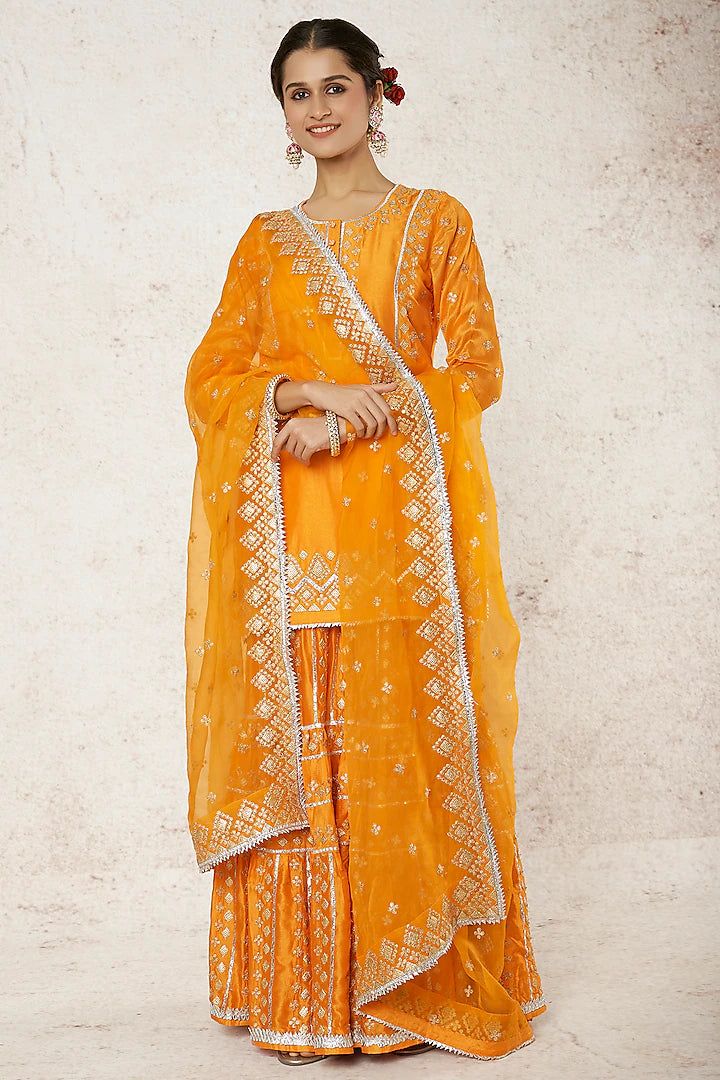 Aman Takyar | Mustard Gold Embroidery Kurta Sharara Set | INDIASPOPUP.COM Chinon Sharara With Gota Work And Straight Kurta, Sharara With Gota Work And Straight Kurta In Chinon, Orange Sharara With Straight Kurta And Pallu, Gold Kurta With Gota Work For Transitional Season, Embroidered Yellow Dola Silk Palazzo Set, Yellow Chikankari Embroidery Palazzo Set For Eid, Traditional Gold Palazzo Set With Chikankari Embroidery, Chinon Sharara With Gota Work For Transitional Season, Gold Chanderi Palazzo Set With Traditional Drape