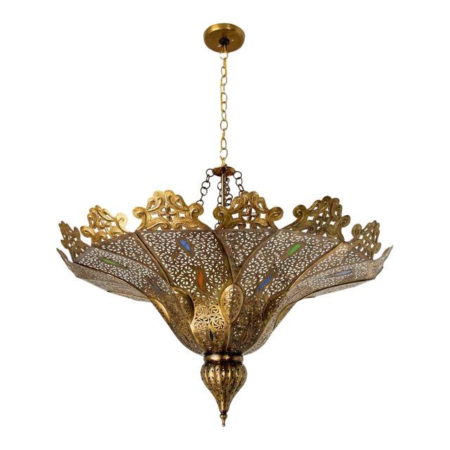 an ornate chandelier hanging from a chain