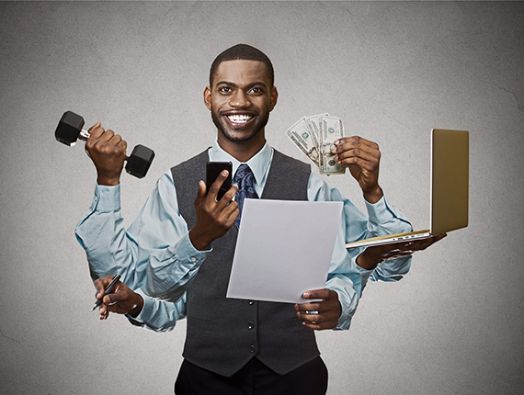 a man holding two dumbs and an open laptop in one hand with money on the other